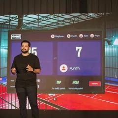 A presenter at our launch event showcases the smart court scoreboard interface, which allows for easy point tracking during a badminton game.