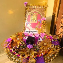 A full view of the divine Radha Krishna engagement platter, showcasing the intricate gold details, peacock motifs, and the central ring box.