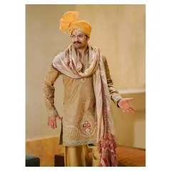 A welcoming gesture from the groom. This candid portrait captures his warm personality and the intricate embroidery on his traditional wedding kurta.