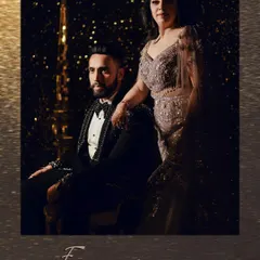 A regal and timeless portrait of the couple. The dramatic lighting and their elegant attire create a classic, formal look that is perfect for an engagement or reception album.