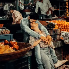 An intimate moment shared amidst the vibrant chaos of a Mumbai flower market. We specialize in finding unique, unconventional locations for pre-wedding shoots that tell a story authentic to you and the city.