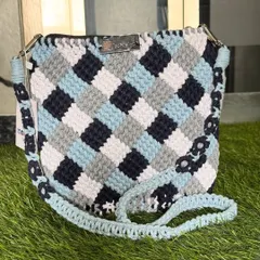 A closer look at the blue and grey checkered sling bag. The strap even has little flowers knotted into it for an extra special touch.