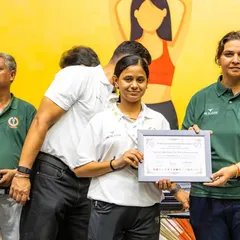 A participant receiving her certificate at the PSPB Summer Camp. The camp provided elite training from national and international coaches.