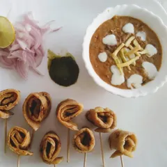 A creative presentation of a comforting meal. Here, I've served a rich, creamy dal alongside whole wheat roti pinwheels, perfect for dipping. It’s a fun twist on the classic dal-roti.