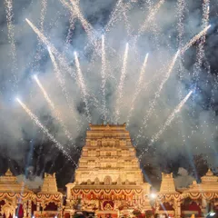 The backdrop for this varmala was a magnificent temple replica, and I used a massive fireworks display to frame the entire scene. This wide shot shows the sheer scale and grandeur of the moment.