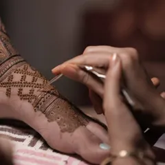The art of precision. This shot captures me creating a fine, geometric jaali (net) pattern on a bride's foot with a henna cone.