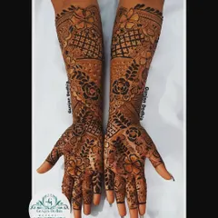 A custom full-hand floral design. The pattern is dense with flowers and leaves, creating a lush, garden-like effect that is perfect for any celebration.
