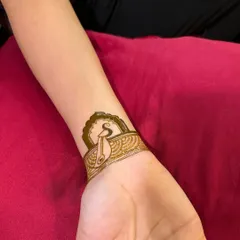 The wristband design taking shape. A patterned cuff is added below the initial, creating a chic and personalized henna bracelet.