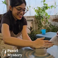 The pure joy of seeing the clay respond to your touch. This is a perfect shot of a guest fully immersed and smiling as she learns the art of wheel throwing in our studio.