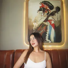 Enjoying the ambiance. The white top is a versatile piece that works in any setting, from a quirky cafe to a chic restaurant.