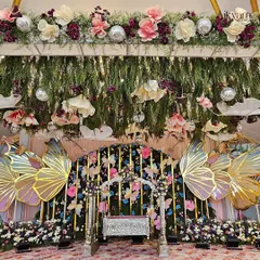Showcasing my love for whimsical and unique themes, this butterfly-themed naming ceremony features iridescent butterfly wings, a floral cradle, and hanging disco balls for a touch of magic.