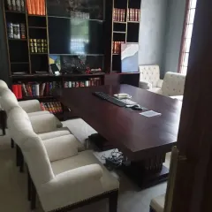 A closer view of the conference room, designed with warm tones and classic furniture to create a professional and inviting atmosphere for meetings.