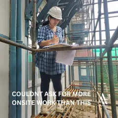This is what our hands-on internship is all about. An intern stands on scaffolding at a live restoration site, reviewing architectural plans. We believe in learning by doing, and our interns gain invaluable experience in practical site management and conservation techniques.