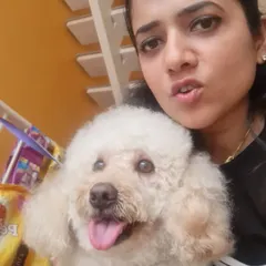 A happy selfie with a freshly coiffed Poodle. We offer a complete suite of grooming services including spa baths, nail trimming, and stylish haircuts to pamper your pet.