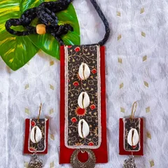Here, I've blended traditional Kalamkari print fabric with natural cowrie shells and oxidized metal charms. The rectangular pendant creates a modern silhouette, while the materials give it an earthy, ethnic feel. The matching earrings feature ghungroo details for a subtle sound.