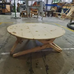 This collapsible round table demonstrates clever design and precise execution. Our students learn to create functional furniture that incorporates smart mechanisms, like this folding leg assembly for easy storage.