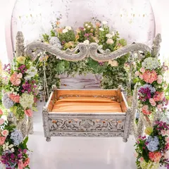 A close-up of the star of the show: the intricately carved silver cradle. We surrounded it with towers of fresh, colorful flowers, making it a worthy centerpiece for welcoming baby Inara.