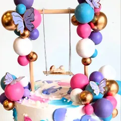 A close-up of the adorable baby on the swing. This 2kg eggless White Chocolate-Raspberry cake uses fondant only for the rainbow and teddies.