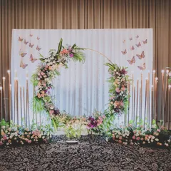 I believe in creating elegant and timeless setups for life's biggest moments. This engagement backdrop features a stunning floral ring against a delicate sequin wall, flanked by dramatic flower stands for a truly romantic photo corner.
