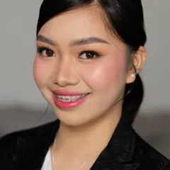 A clean and professional corporate makeup look. The makeup is minimal and fresh, with a focus on even skin, defined brows, and a pop of color on the lips to look polished and confident.
