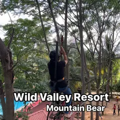 A guest navigates the sky cycling course at our Mountain Bear resort. This activity requires balance and courage as you pedal your way across a cable high above the ground.