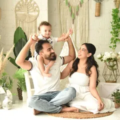 A perfect family moment with their little one on dad's shoulders. My boho studio setup provides a warm and relaxed backdrop for family portraits.
