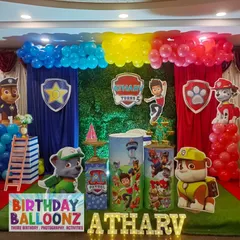 This Paw Patrol themed birthday stage brings Adventure Bay to life. The setup includes character-specific sections for Chase and Marshall, a central green backdrop, themed pedestals, and a bright, light-up name sign to make the birthday boy the star of the show.