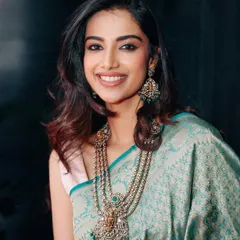 A beautiful portrait in a light teal silk saree, paired with a stunning multi-layered traditional necklace. This styling balances classic elegance with a soft, modern feel.