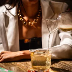 A lifestyle moment at Lyla Bombay, capturing a drink being poured at the table. This action shot makes the scene feel alive and engaging.