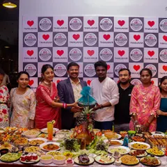 We love being part of your celebrations. Here, guests are seen enjoying the festive atmosphere created by our impressive buffet spread, a testament to the joy our food brings to any occasion.
