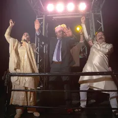 Hands in the air. This is a moment of pure, uninhibited celebration during the groom's procession. The lights, the music, the energy, it's all electric.