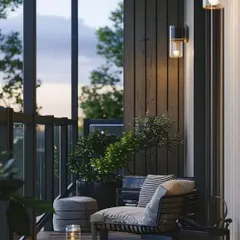 Highlighting the power of good lighting, this minimalist balcony uses wall-mounted sconces and floor lanterns to create a moody and elegant ambiance. The simple wooden deck and comfortable seating make it a perfect spot for quiet evenings.