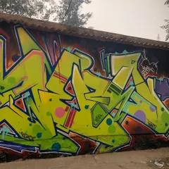 The other half of the mural, focusing on my signature 'wildstyle' graffiti lettering. The sharp, interlocking letters in vibrant lime green create a dynamic contrast with the figurative work.