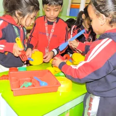 Students in uniform work together at a pretend play station. My play zones encourage teamwork and social interaction through imaginative, hands-on activities.