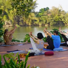 We take our practice into nature whenever we can. Here, our teacher training students find their focus and flexibility during an asana session on our riverside patio, connecting their breath with the gentle sounds of the water.