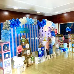 A large-scale Boss Baby party with multiple decor stations, including a striped backdrop and large 'BOSS' blocks.