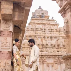 Using the temple's magnificent gopuram as the backdrop, this shot emphasizes the scale and cultural significance of the setting, making their love story feel epic.