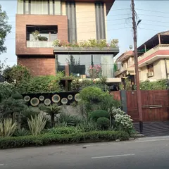 This Noida residence showcases how landscaping can be integrated with modern architecture. I designed and installed multi-level greenery, including rooftop gardens, balcony planters, and a dense, sculpted front yard to complement the home's unique facade.