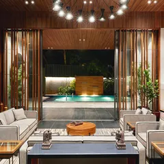 We designed this garden lounge for The Bandra Project to seamlessly connect indoor luxury with serene outdoor living, creating a private, versatile space for residents that opens directly to a leisure pool.