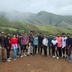 A moment of achievement for our trekking group at Kudremukha. The rolling green hills provide a stunning backdrop for making new friends and unforgettable memories on this classic Karnataka trek.