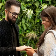A beautiful, candid moment during the ring ceremony. The groom's happy gaze and the bride's gentle smile say it all.