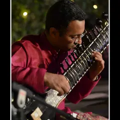 A close-up shot during an evening concert at the Constitution Club in Delhi, playing Raag Kedar. The soft lighting reflects the serene mood of the music.