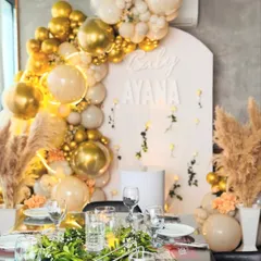 This glamorous Aqiqah celebration for Baby Ayana was all about elegance. We created a stunning photo corner with a cascade of gold and white balloons, pampas grass, and a custom backdrop, perfectly complementing the intimate dining setup.