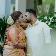 A candid moment of love and laughter between the bride and groom, her jasmine-adorned hair and his simple elegance defining the beauty of a Kerala wedding.