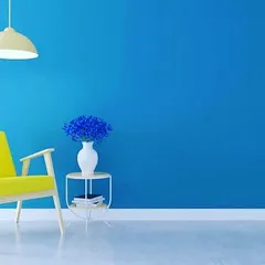 Consider a bold accent wall to bring life to your interior. This bright blue wall creates a cheerful and energetic atmosphere, perfect for a living room or creative space.