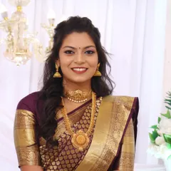 The complete South Indian bridal look, with makeup that enhances her features and complements the rich colors of her saree.
