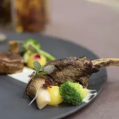 A close-up of our grilled lamb, showcasing the beautiful char marks and the fresh vegetables that accompany it.
