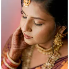 A serene and beautiful close-up of the bride-to-be on her engagement day, highlighting her traditional jewelry and makeup.