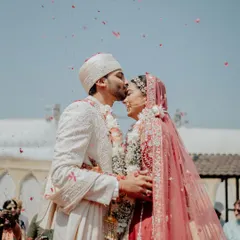 Sometimes, the most powerful moments are the quietest. This forehead kiss during the wedding ceremony is a classic shot, but it’s the genuine emotion and the shower of petals that make it special. It showcases our focus on capturing intimate, heartfelt connections amidst the grandeur of the wedding day.