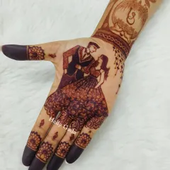 A beautiful engagement design with a dancing couple on the palm and their initial "S" in a logo on the arm.